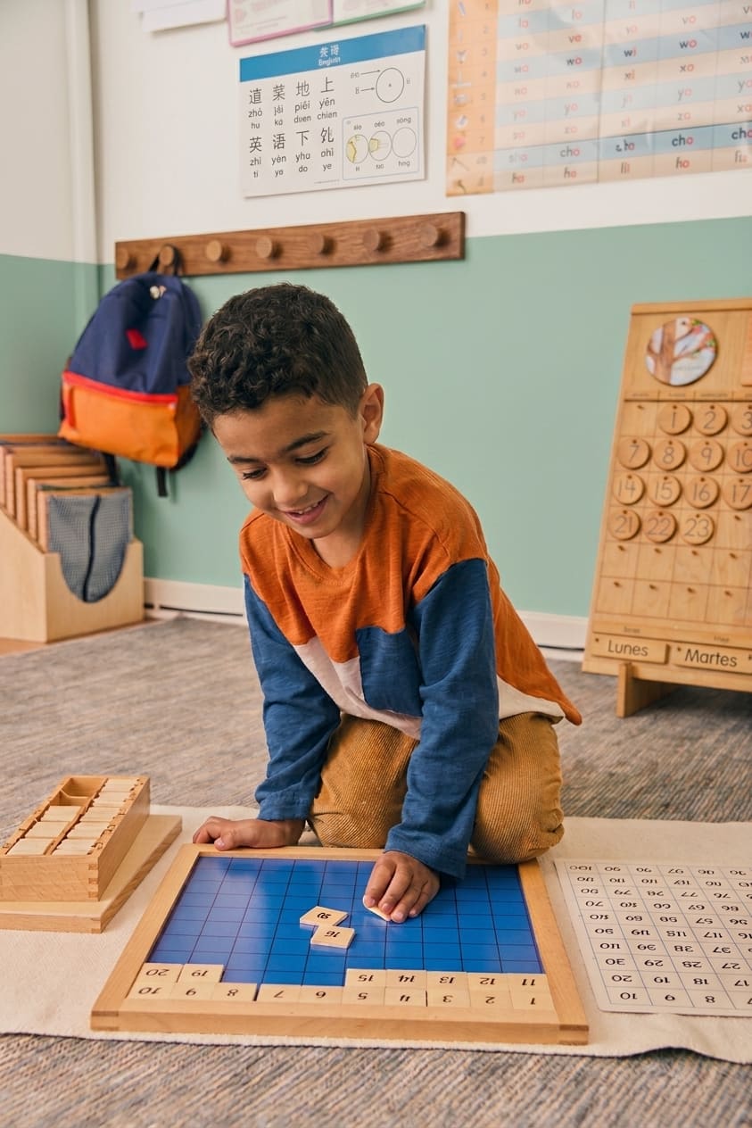 A child working with a number board in our FS1 room